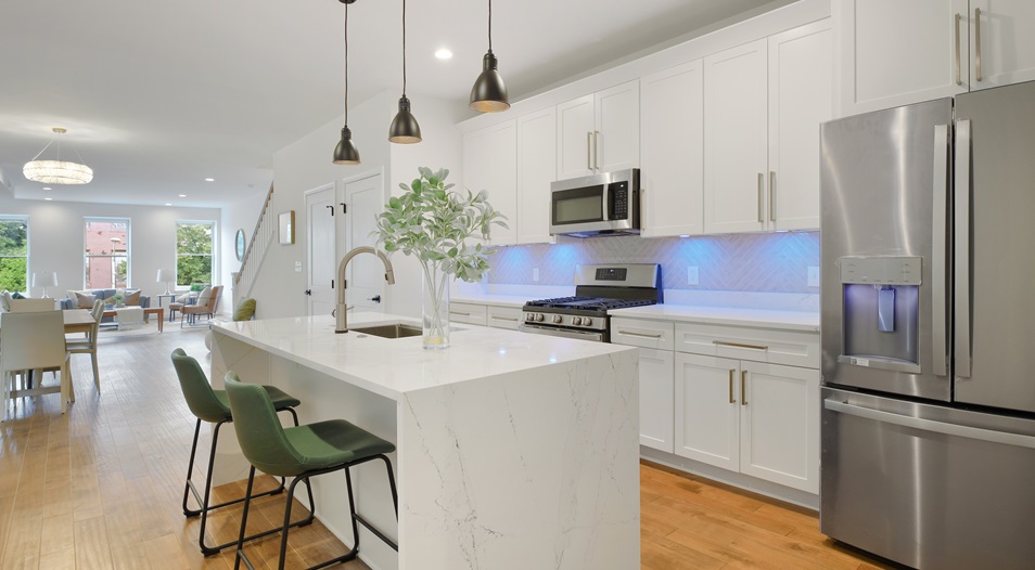 A renovated kitchen with white cabinets