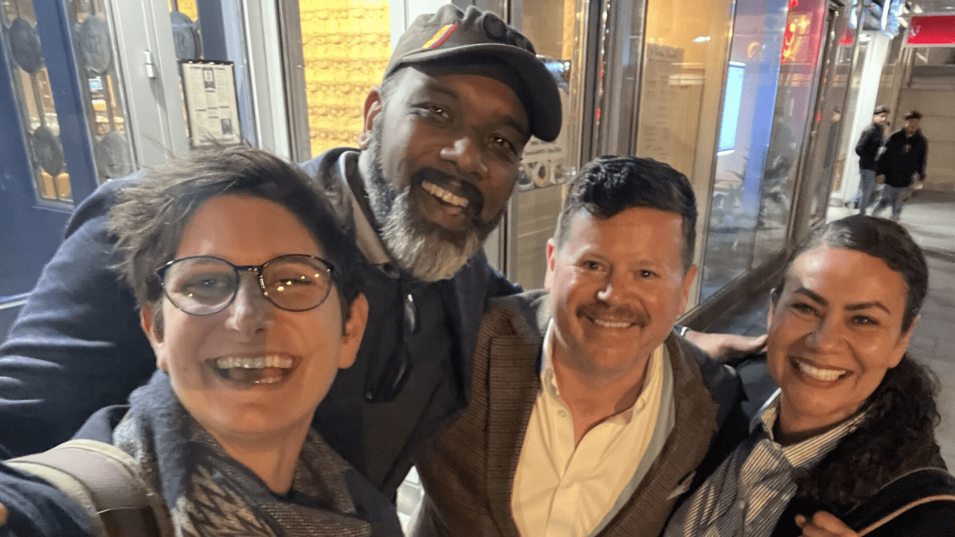 A group of four people posing for a photo.