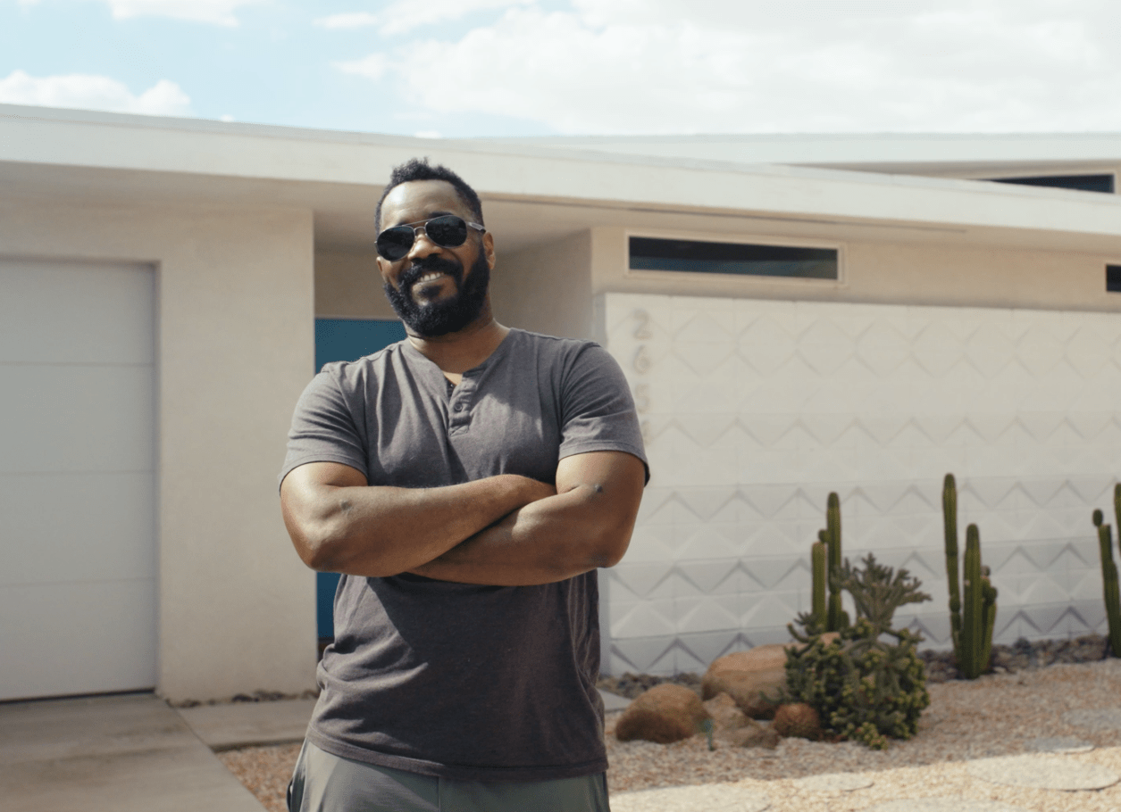 D'Andre stands in front of his home.